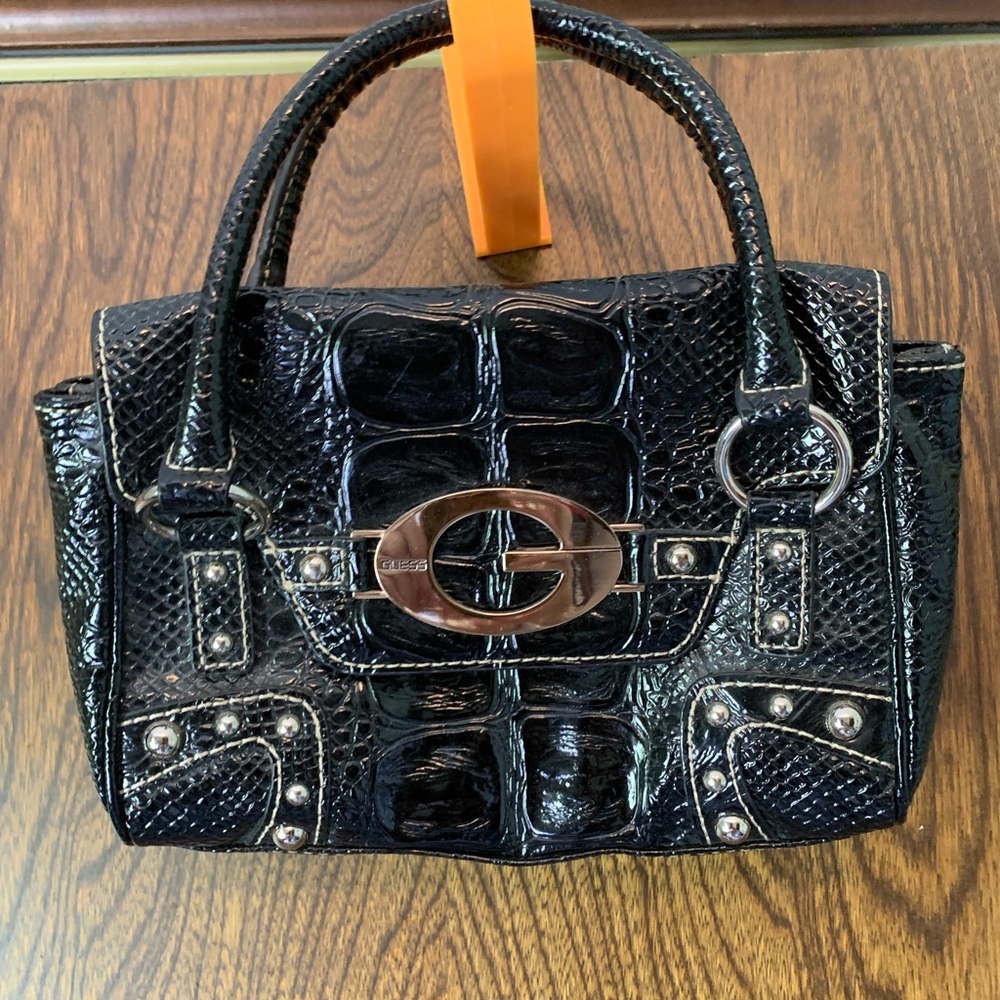 Small gas handbag silver and black small zipper pocket on the inside.